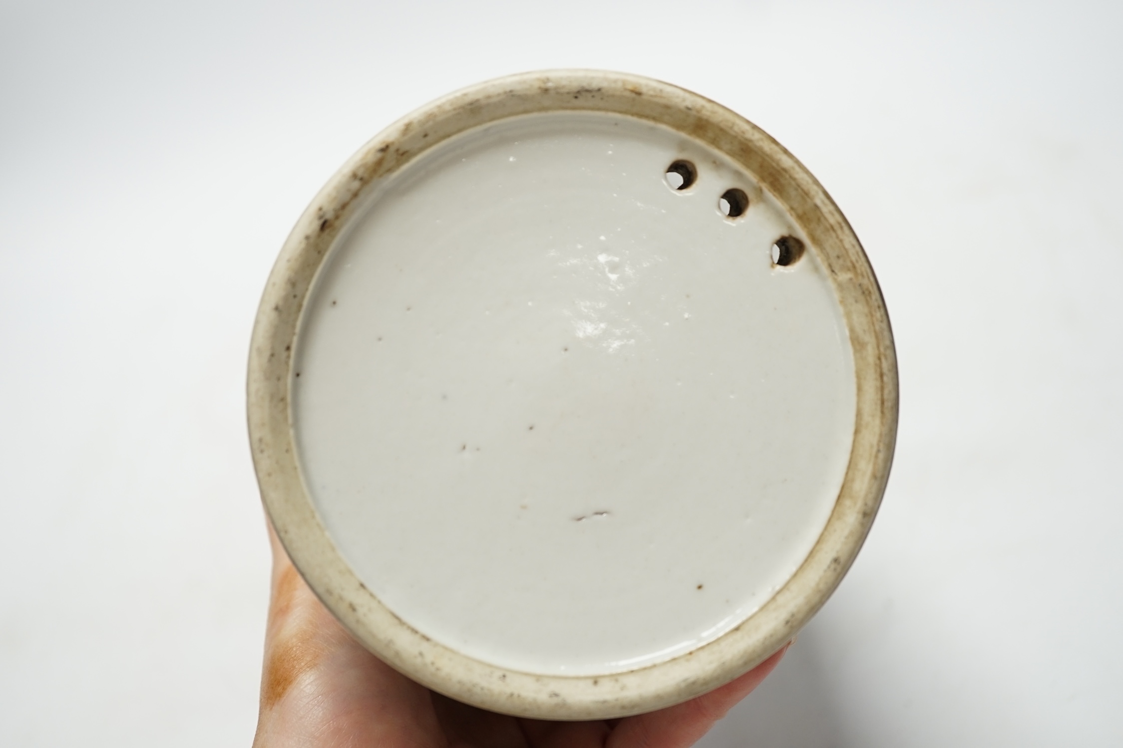 A 19th century Chinese cylindrical blue and white brushpot, later drilled holes, 15cm